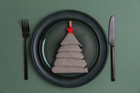 Elegant Christmas Table Setting with Napkin Tree and Red Star Ornamentの写真素材