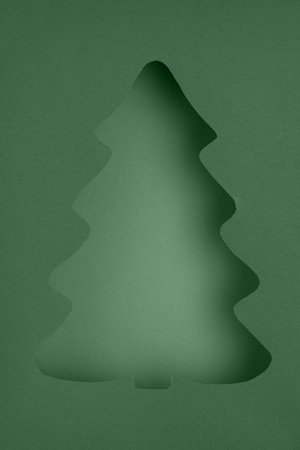 Stylized Christmas Tree Cutout on Layered Green Paperの写真素材