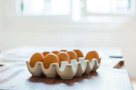 Dozen eggs in a cassette on a tableの写真素材
