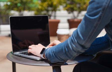Woman is working on her laptop outside