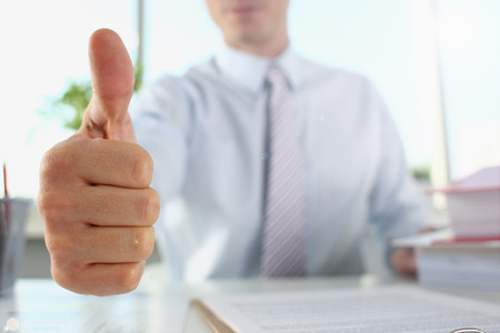 Close up of a businessman showing a thumbs up gestureの写真素材