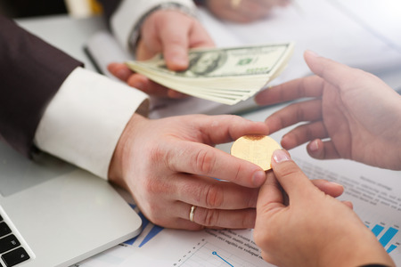 businessmen change currency make successful deal hold money in arms wealth conceptの写真素材