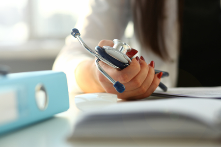 Female doctor hand hold phonendoscope in medical hospital resuscitation backgroundの写真素材