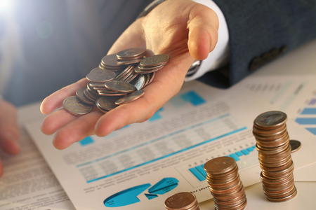 Hand businessman hold money. Future needs loan education or mortgage credit spend vacation of dream effective buying financial risk and safety conceptの写真素材