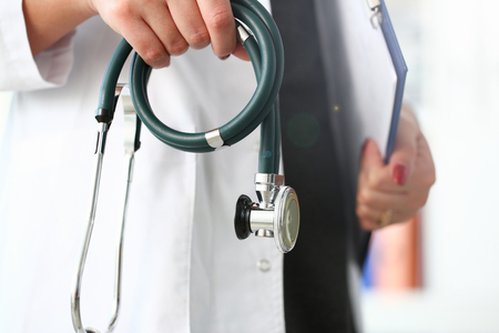 Female doctor hand hold phonendoscope in medical hospital resuscitation backgroundの写真素材