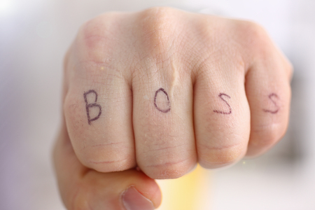 Male clenched fist in suit at office closeup. Aggressive career strategy angry negotiation strong riot solution for freedom victory leader decision boss tattoo control participation conceptの写真素材