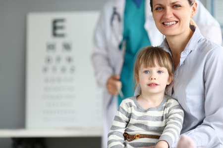 Happy smiling family at child doctor office portraitの写真素材