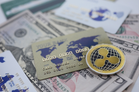 Silver coin ripple XRP closeup lie on moneyの写真素材