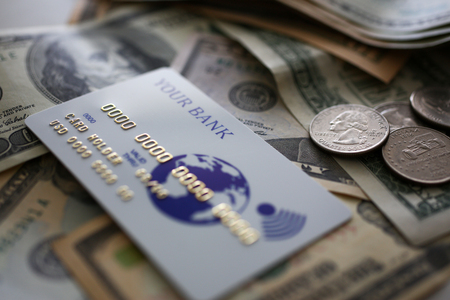 Credit card lying at big amount of US currencyの写真素材