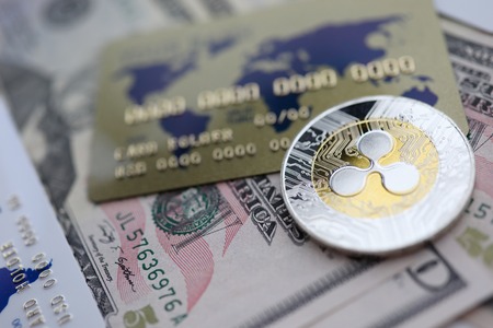 Silver coin ripple XRP closeup lie on moneyの写真素材