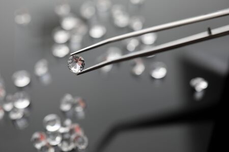 Forceps holding little diamond closeupの写真素材