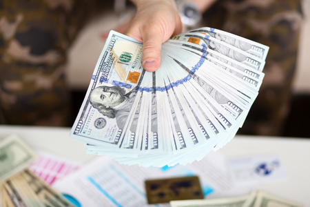 Man hold in hand big fat pack of US moneyの写真素材
