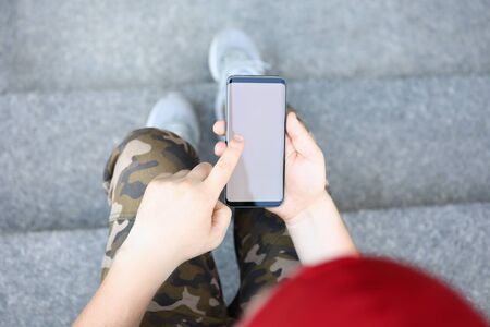 Male hands holding smartphone closeupの写真素材