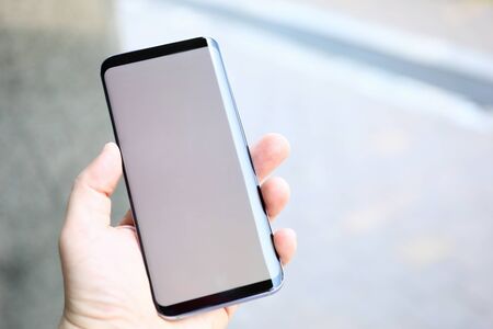 Male hands holding smartphone closeupの写真素材
