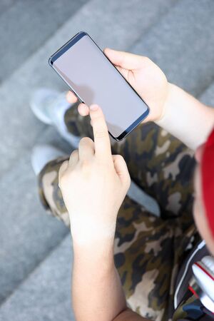 Male hands holding smartphone closeupの写真素材