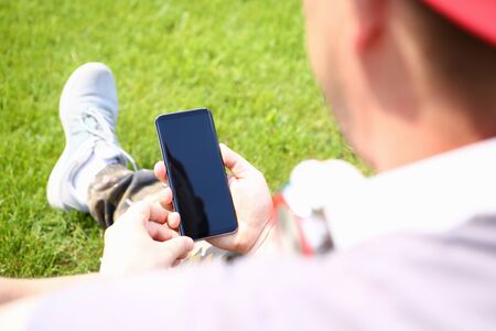 Male hands holding smartphone closeupの写真素材