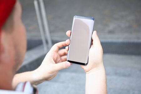 Male hands holding smartphone closeupの写真素材