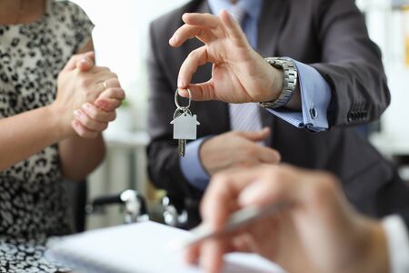 Hand of realtor hold a house keyの写真素材