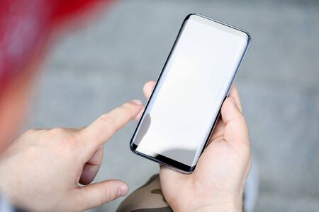Male hands holding smartphone closeupの写真素材