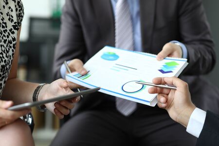 Male hand holding financial diagram closeupの写真素材