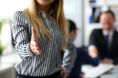 Female manager offering arm as hello to future clientの写真素材