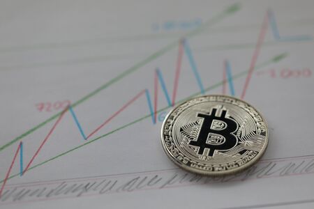 Focus on distinctive and significant currency lying on important corporate papers with charts and graphs that show profit and income. Blurred backgroundの写真素材
