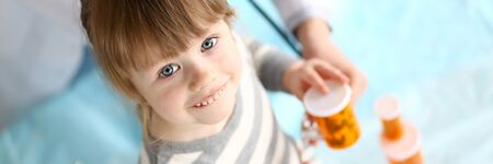 Cute little girl at doctor reception getting medications prescriptionの写真素材