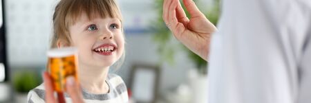 Cute little girl at doctor reception getting medications prescriptionの写真素材
