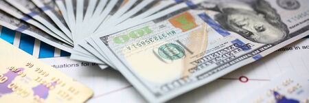 Big amount of US currency on financial statistics graphsの写真素材