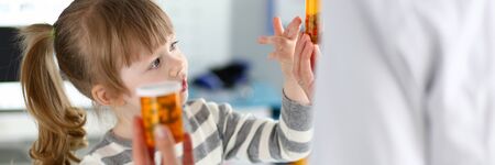 Cute little girl at doctor reception getting medications prescriptionの写真素材