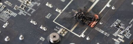 Closeup view of damaged graphic adapter burnt out after hackの写真素材