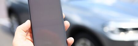 Male hand hold smartphone with blankの写真素材