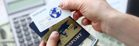 Male arms holding passport banking pack of USの写真素材