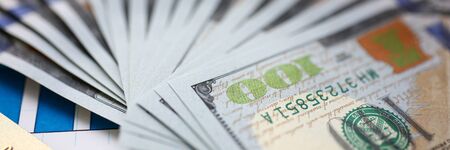 Huge pack of US money and bank card lying down on important financial documentの写真素材