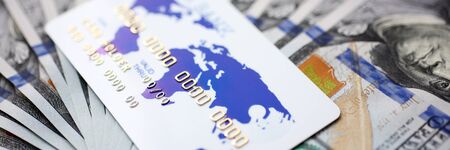 Huge pack of US money and bank card lying down on important financial documentの写真素材