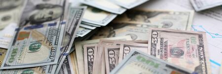 Big pile of US money lying down in random order