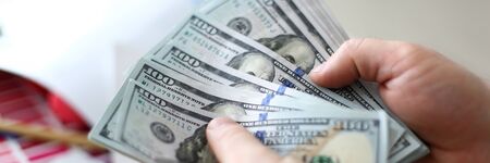 Male hands counting money from huge packの写真素材