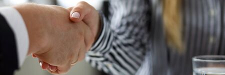 Man and woman shaking hands after productive deliberationsの写真素材