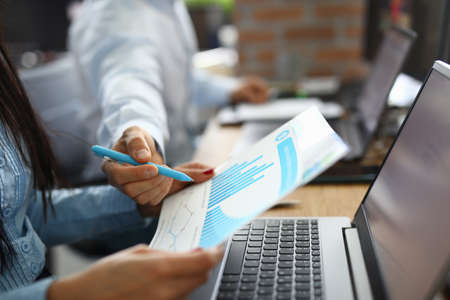Man and woman at desk analyze graph. Business process planning and development concept