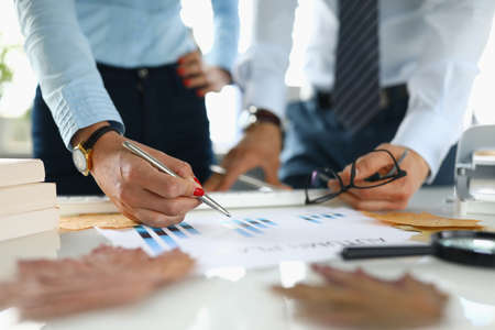 Businessman and businesswoman in office analyze autumn plan.