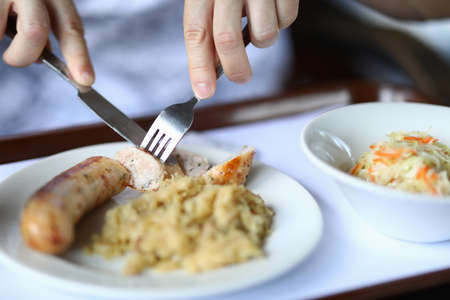Sausage dish and garnish with salad closeup.の写真素材