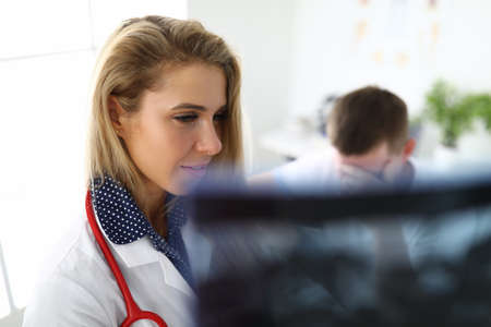 Doctor with patient with disappointed look at the X-rayの写真素材