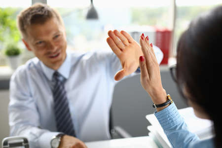 Businessman smiles and greets his colleague closeupの写真素材