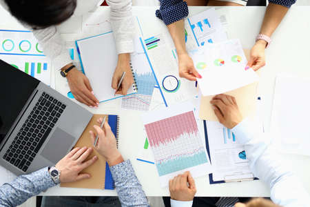 Entrepreneurs sit at table and discuss business performanceの写真素材