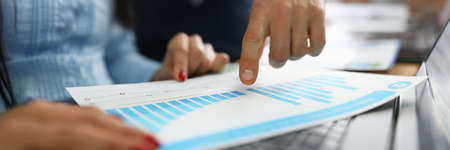 Businessman shows business performance on graph closeupの写真素材