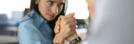 Man and woman are fighting in office in their armsの写真素材