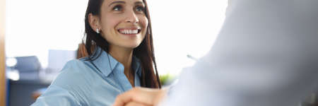 Successful business woman shakes hands with partner.の写真素材