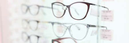 On stand are glasses in beautiful frames. closeup