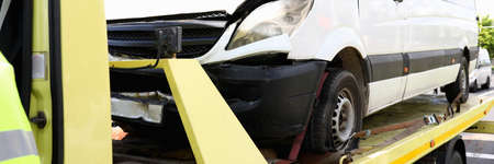 Wrecked car stands on tow truck closeup.の写真素材