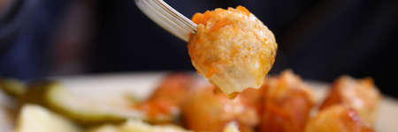 Dish of meatballs mashed potatoes and picklesの写真素材